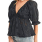 Black Eyelet Peplum Top with Deep V-Neckline