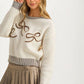 Knit Sweater with Textured Bow Embroidery and Striped Trim