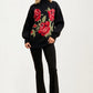 Black Turtleneck Sweater with Bold Red Rose Design