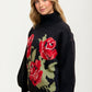 Black Turtleneck Sweater with Bold Red Rose Design